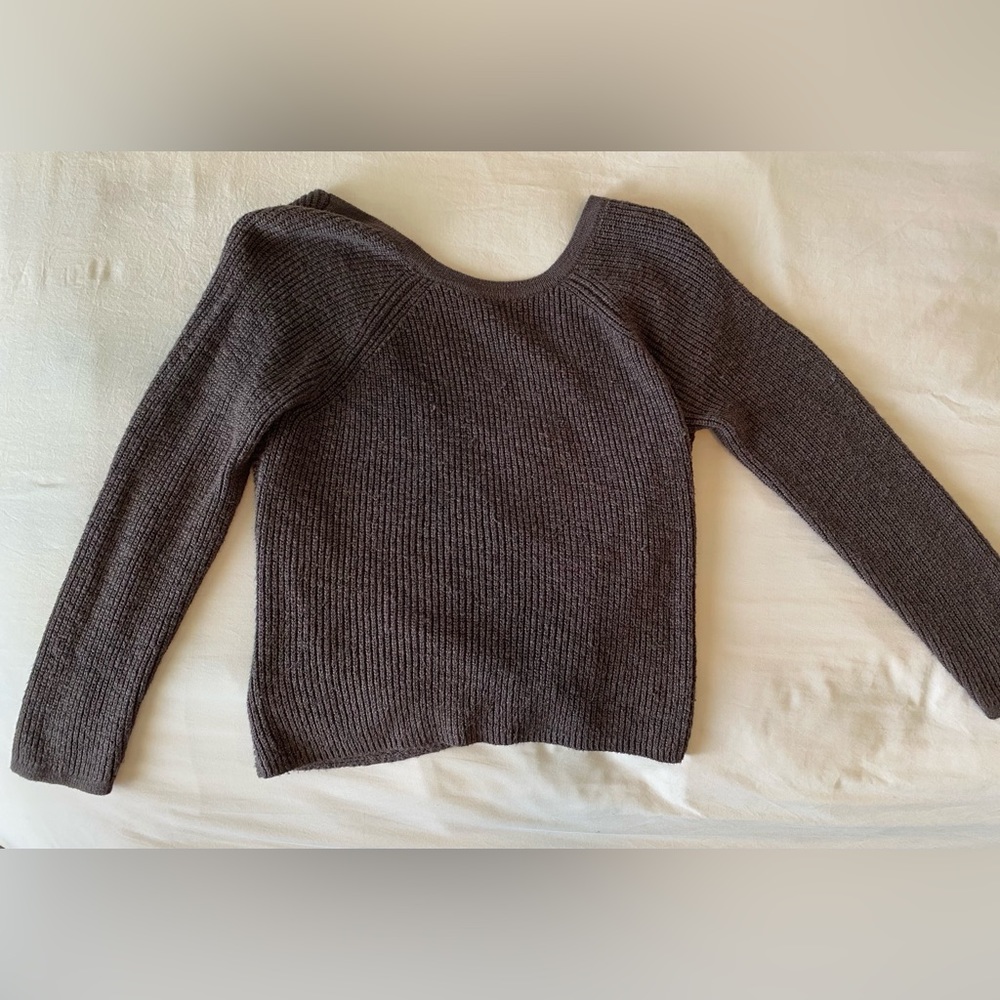 Loose sweater with open back.